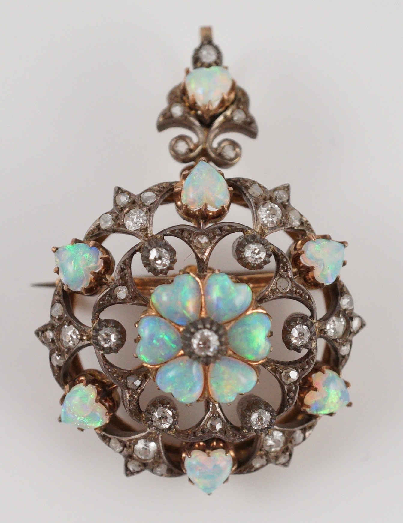 A late Victorian gold silver and diamond circular cluster pendant brooch, 3.5cm, gross 17.5 grams